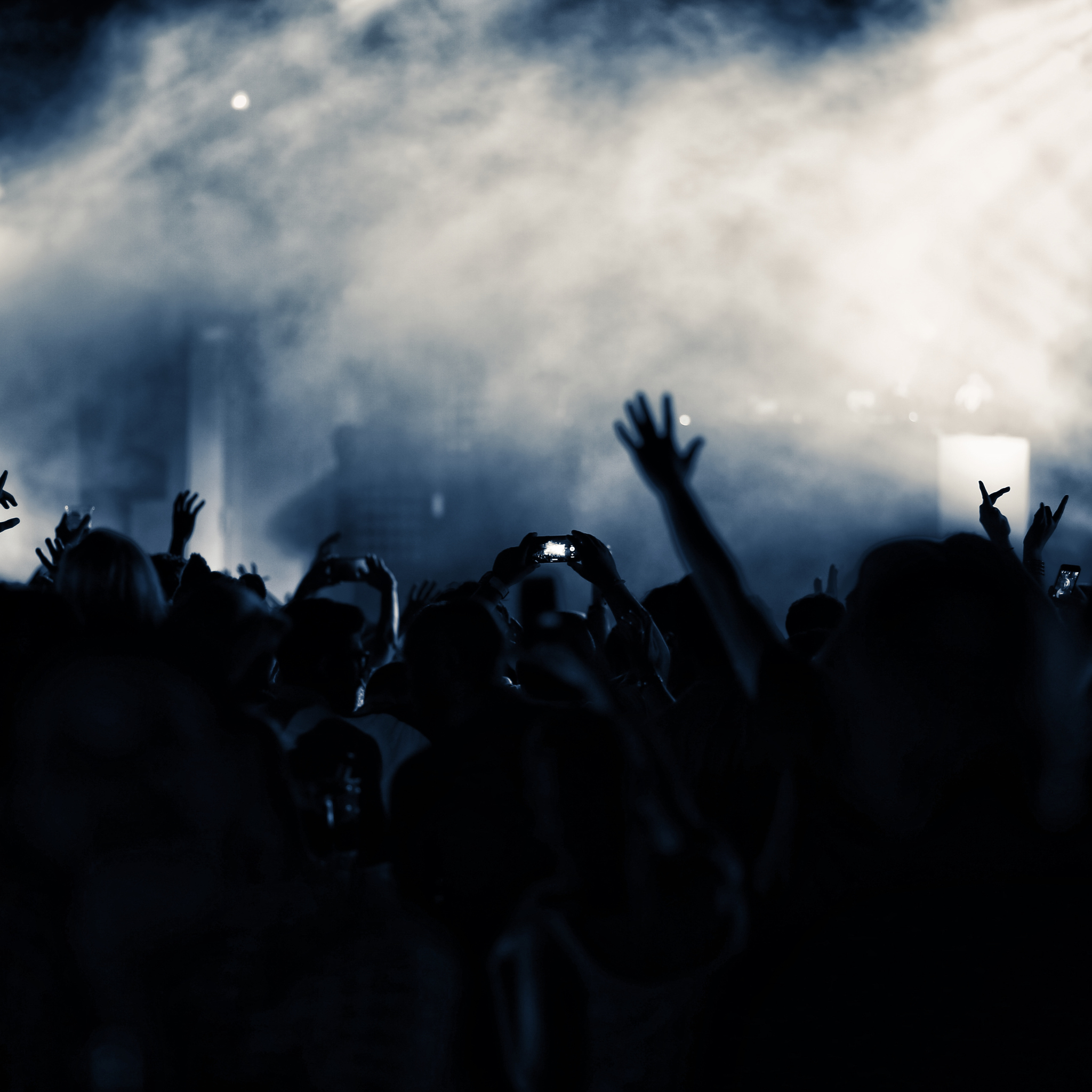 dancefloor avec invites mains levees sous fumee et lumieres de scene en soiree mariage mixte